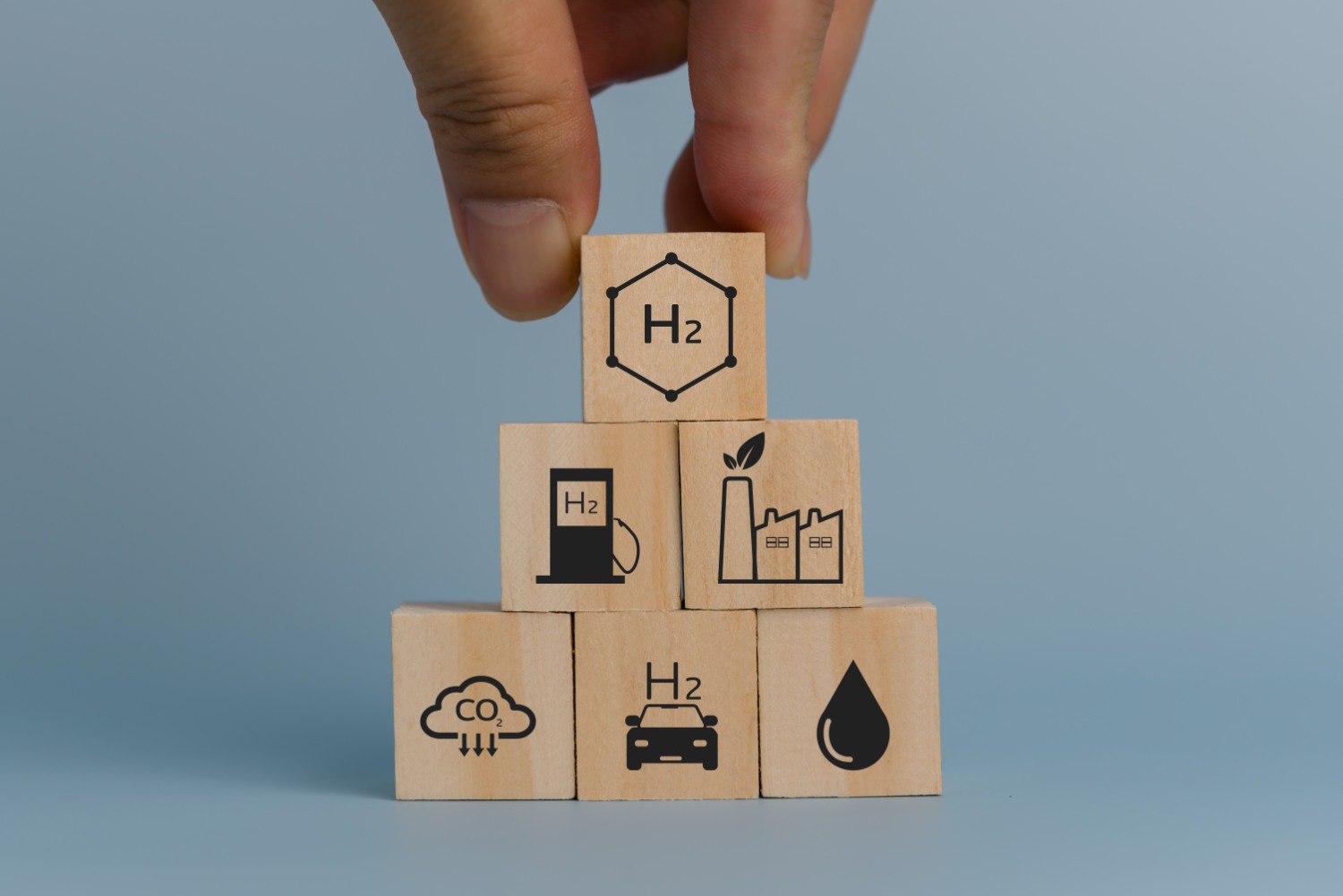 hand stacking blocks with eco-friendly icons